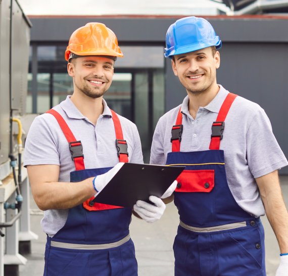 Two construction workers reviewing plans